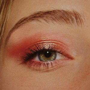 woman with pink and gold eyeshadow makeup