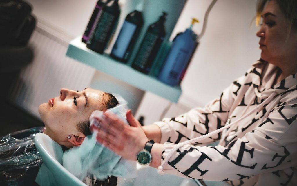 a man getting his hair washed in a salon